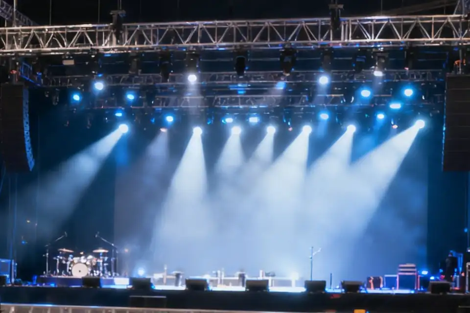 Illustration: a concert stage with lighting beams through haze between line arrays